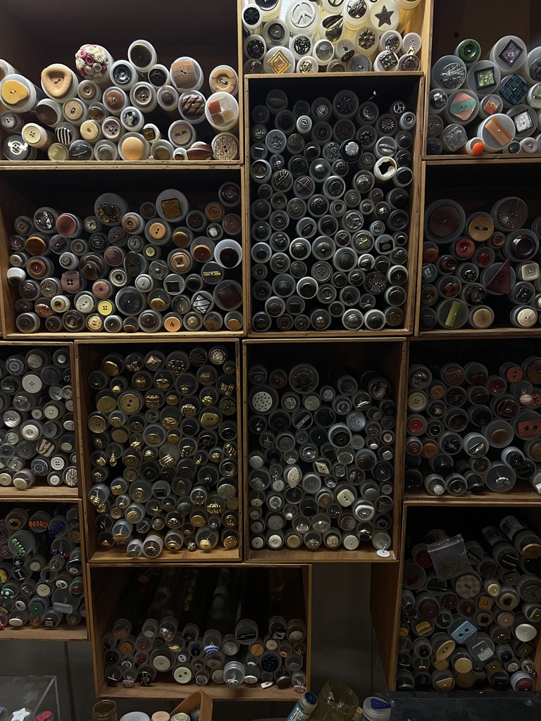 Hundreds of buttons sorted into wooden compartments by color and material