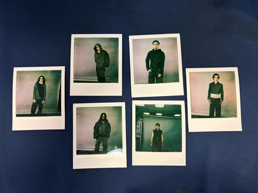 Seven instant photographs of models wearing the collection arranged on dark blue cloth